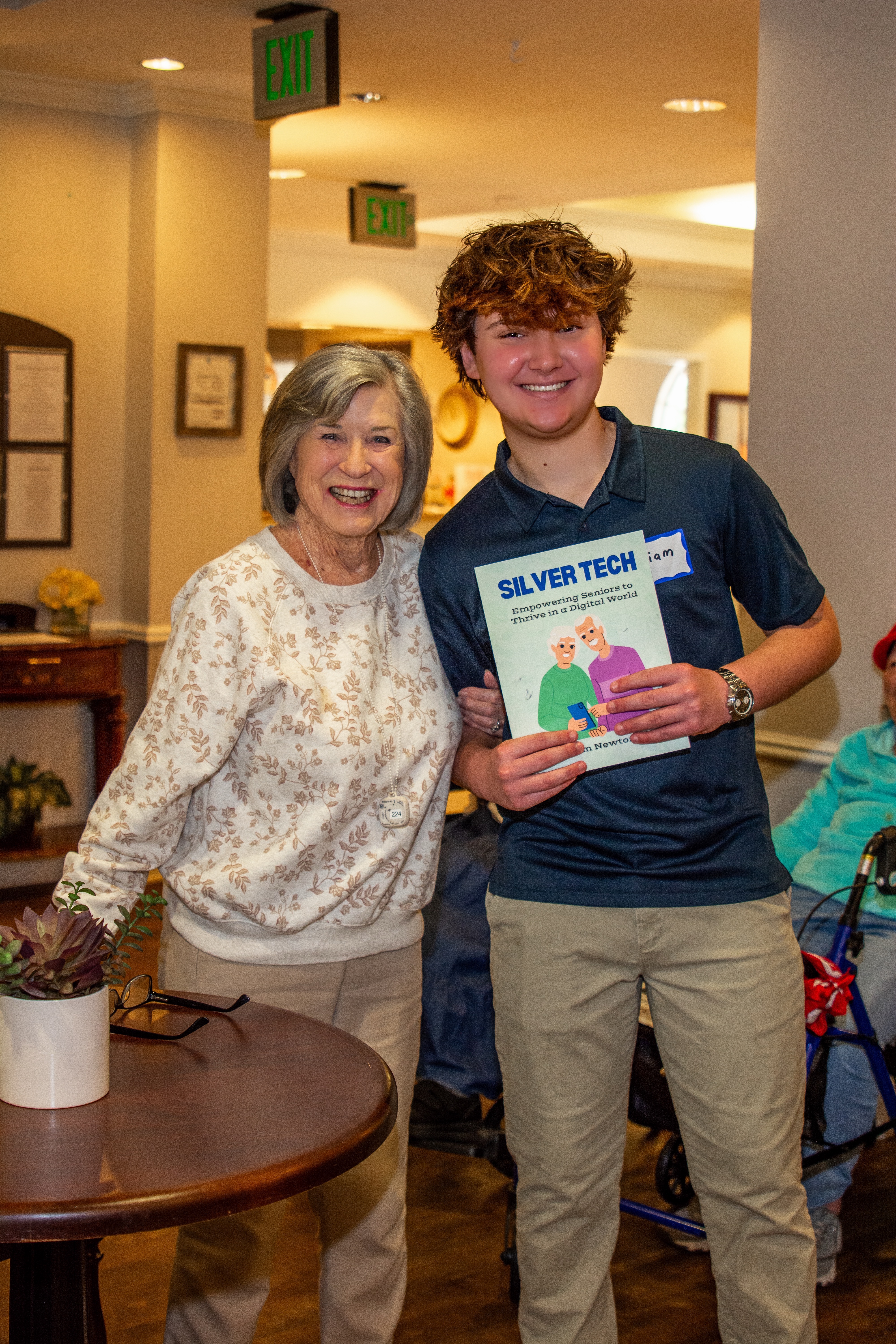 Liam with senior holding Silver Tech book