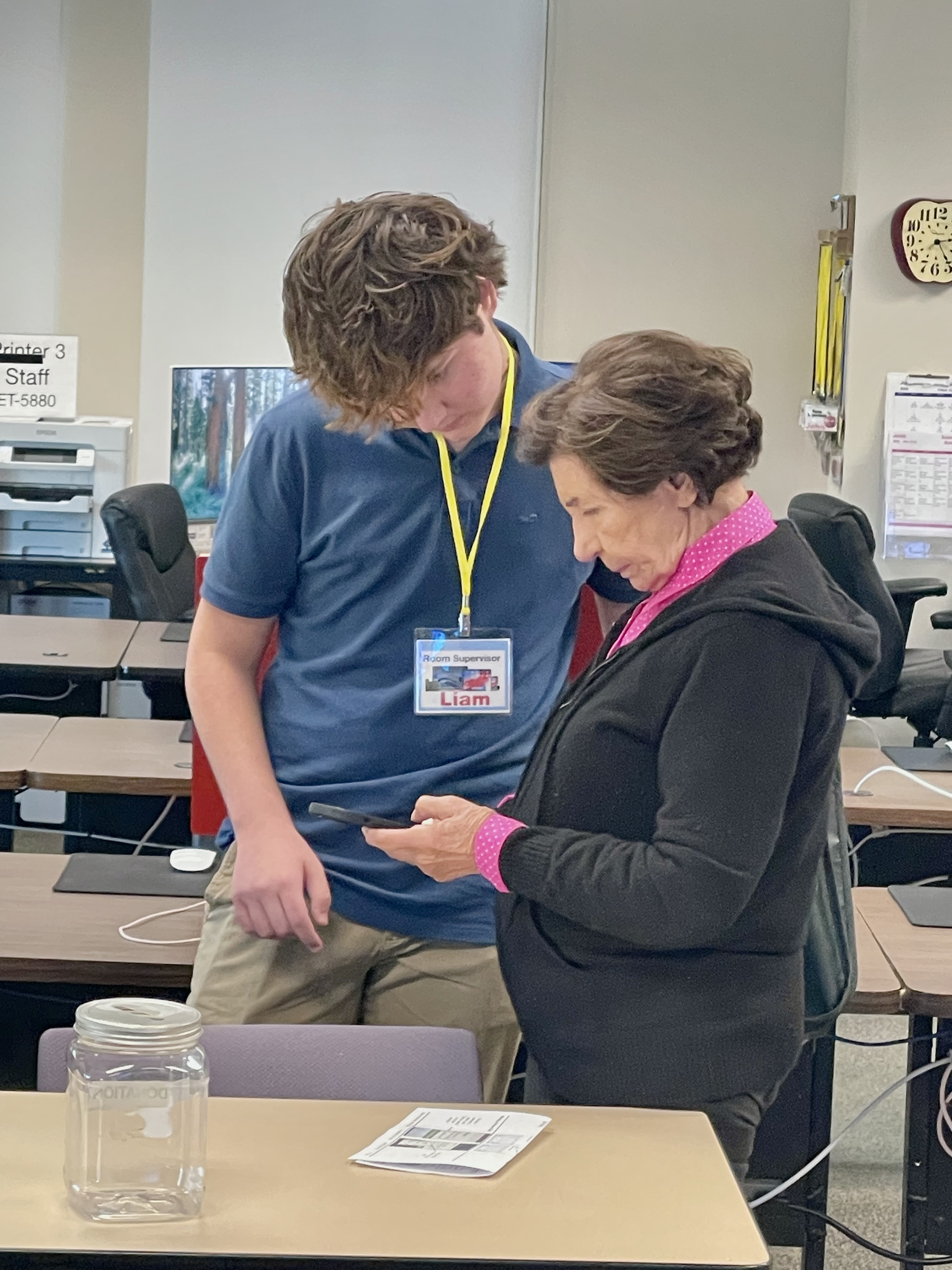 Liam helping senior with phone